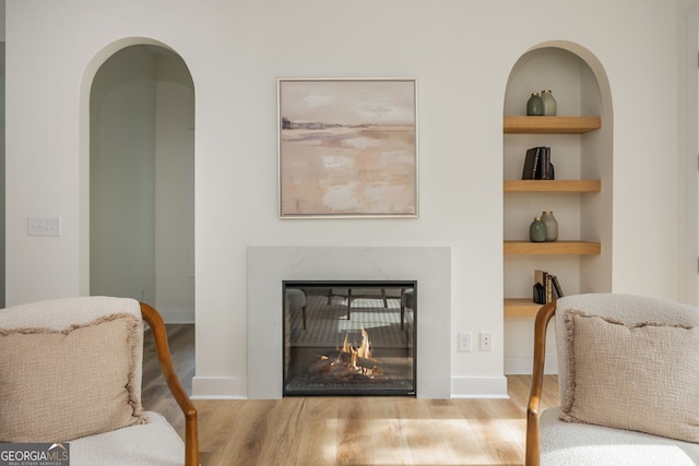 38 Mildred Pl NW, Atlanta, GA 30318 - living room with wood finished floors, built in features, and a high end fireplace
