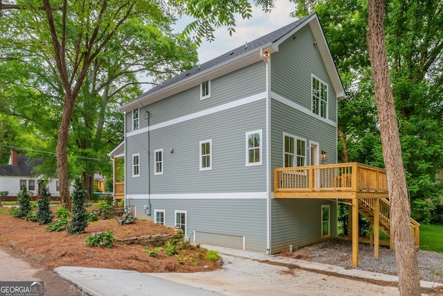 38 Mildred Pl NW, Atlanta, GA 30318 - view of side of home with stairs, a wooden deck, dirt driveway, and a carport