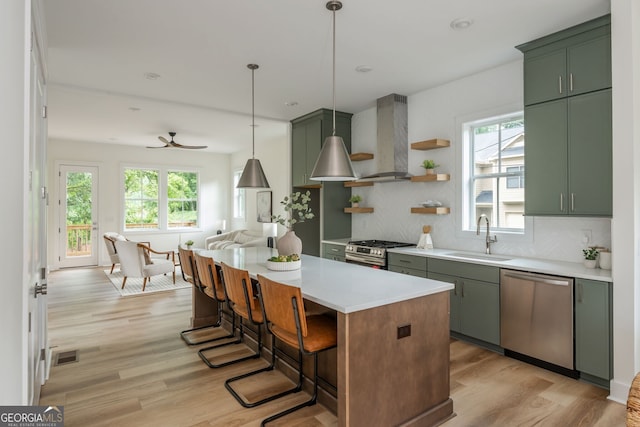 38 Mildred Pl NW, Atlanta, GA 30318 - kitchen featuring green cabinetry, stainless steel appliances, and wall chimney exhaust hood