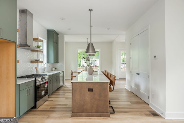 38 Mildred Pl NW, Atlanta, GA 30318 - kitchen with green cabinetry, appliances with stainless steel finishes, exhaust hood, and light wood finished floors