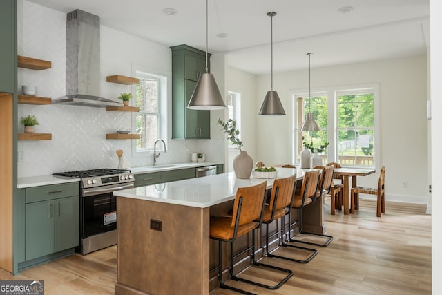 38 Mildred Pl NW, Atlanta, GA 30318 - kitchen featuring open shelves, green cabinetry, wall chimney range hood, and stainless steel appliances
