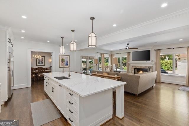 1036 Oxford Rd NE, Atlanta, GA 30306 - kitchen featuring an island with sink, dark wood finished floors, ornamental molding, white cabinetry, and recessed lighting