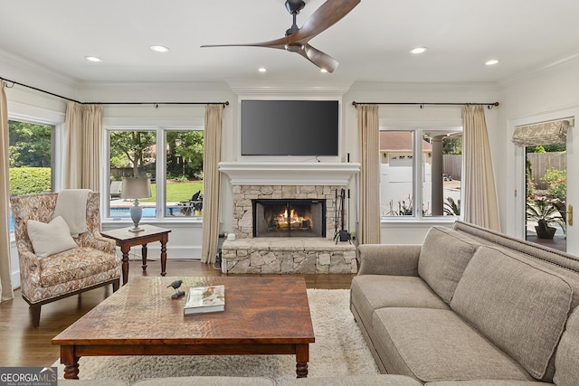 1036 Oxford Rd NE, Atlanta, GA 30306 - living area with crown molding, a stone fireplace, wood finished floors, ceiling fan, and recessed lighting