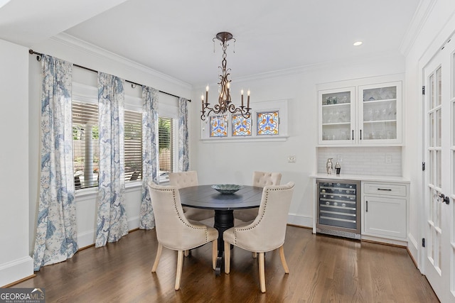 1036 Oxford Rd NE, Atlanta, GA 30306 - dining space featuring wine cooler, a chandelier, dark wood-style flooring, a bar, and crown molding