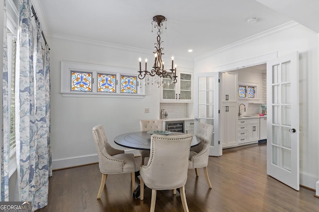 1036 Oxford Rd NE, Atlanta, GA 30306 - dining room featuring beverage cooler, dark wood-type flooring, crown molding, recessed lighting, and a chandelier