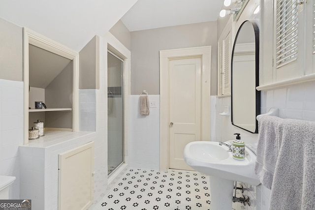 1036 Oxford Rd NE, Atlanta, GA 30306 - full bathroom featuring tile walls, a wainscoted wall, a stall shower, and tile patterned floors