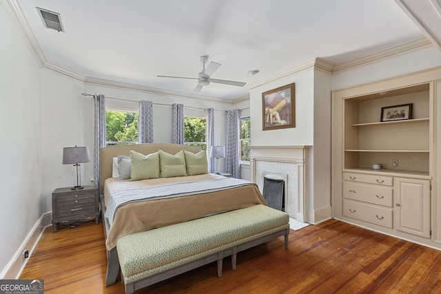 1036 Oxford Rd NE, Atlanta, GA 30306 - bedroom with ornamental molding, wood finished floors, a fireplace, and a ceiling fan