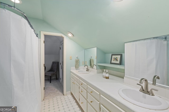1036 Oxford Rd NE, Atlanta, GA 30306 - bathroom with vaulted ceiling, double vanity, and ensuite bathroom