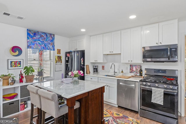 1036 Oxford Rd NE, Atlanta, GA 30306 - kitchen featuring appliances with stainless steel finishes, light countertops, white cabinets, and recessed lighting