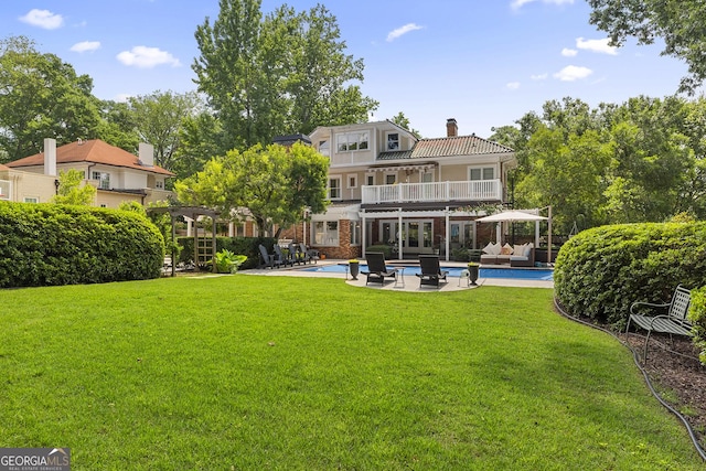 1036 Oxford Rd NE, Atlanta, GA 30306 - back of property with a balcony, a chimney, an outdoor living space, and a lawn