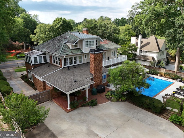 1036 Oxford Rd NE, Atlanta, GA 30306 - rear view of house featuring a chimney, an outdoor pool, and stone siding