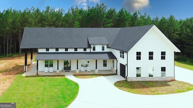 1585 Parks Rd, Forsyth, GA 31029 - view of front of property with covered porch, a shingled roof, driveway, and a front yard