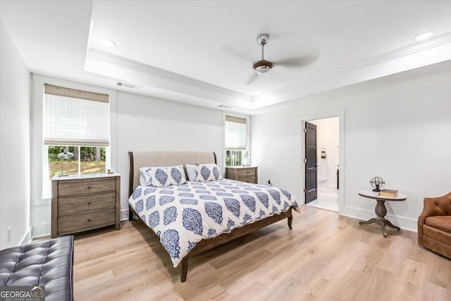 1585 Parks Rd, Forsyth, GA 31029 - bedroom with crown molding, a raised ceiling, light wood-style floors, a ceiling fan, and connected bathroom