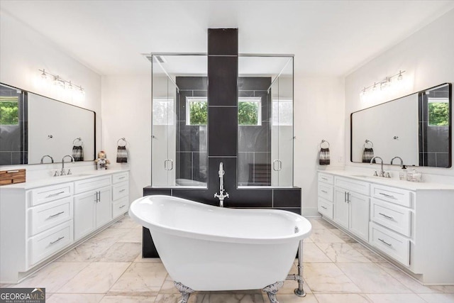 1585 Parks Rd, Forsyth, GA 31029 - full bathroom featuring marble finish flooring, two vanities, a freestanding bath, and a stall shower