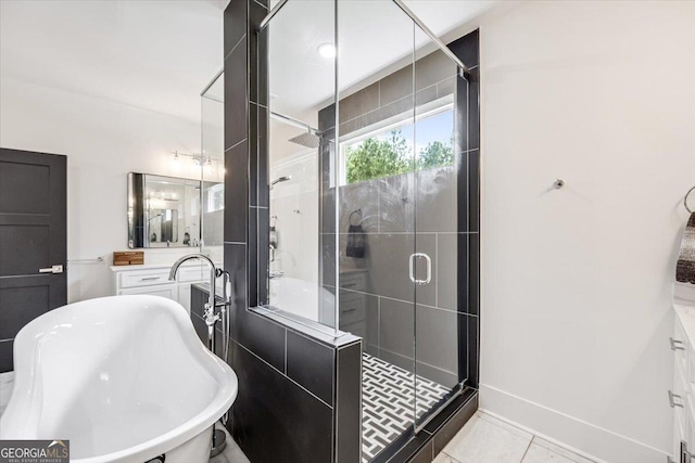 1585 Parks Rd, Forsyth, GA 31029 - bathroom featuring vanity, a stall shower, a freestanding bath, and tile patterned floors