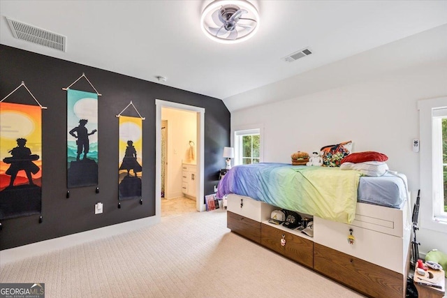 1585 Parks Rd, Forsyth, GA 31029 - carpeted bedroom with vaulted ceiling and ensuite bathroom