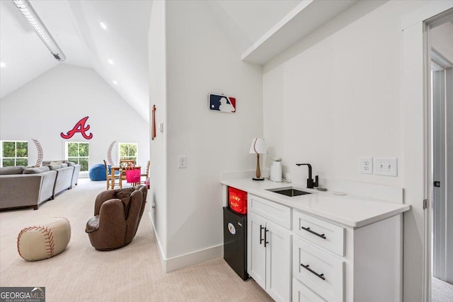 1585 Parks Rd, Forsyth, GA 31029 - indoor wet bar with lofted ceiling, light carpet, and recessed lighting