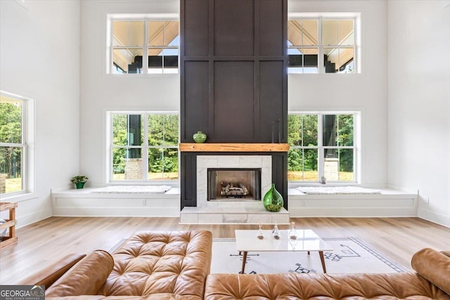 1585 Parks Rd, Forsyth, GA 31029 - living room featuring a high ceiling, a tile fireplace, wood finished floors, and plenty of natural light