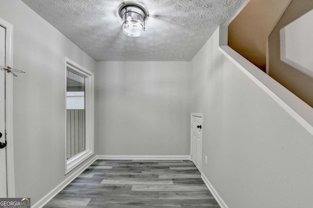 6221 Willow Run Rd, Peachtree Corners, GA 30092 - corridor with a textured ceiling and wood finished floors