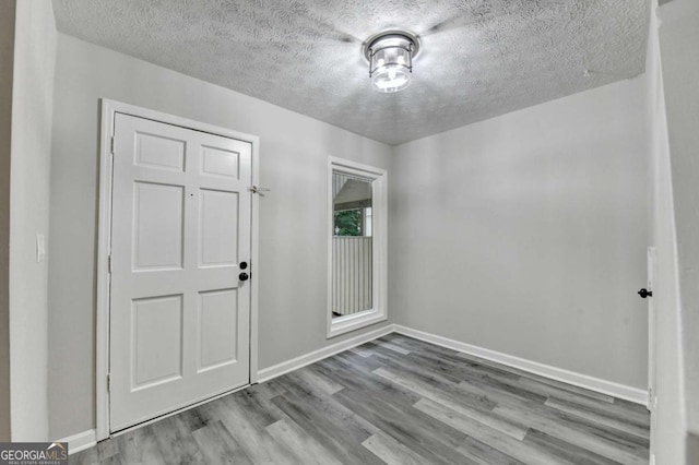 6221 Willow Run Rd, Peachtree Corners, GA 30092 - empty room featuring wood finished floors and a textured ceiling