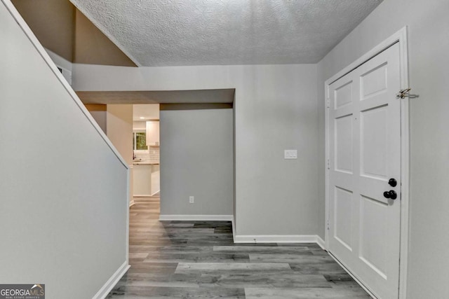 6221 Willow Run Rd, Peachtree Corners, GA 30092 - hall with a textured ceiling and wood finished floors