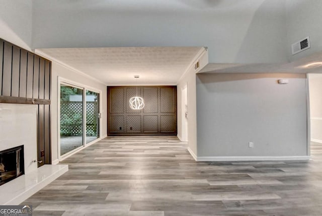 6221 Willow Run Rd, Peachtree Corners, GA 30092 - unfurnished living room with light wood finished floors and a fireplace