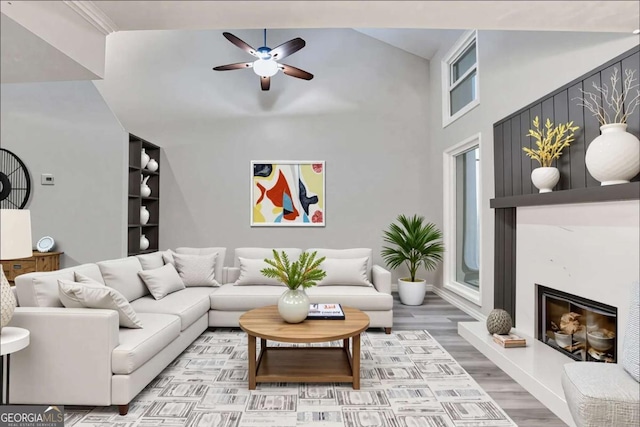 6221 Willow Run Rd, Peachtree Corners, GA 30092 - living area with ceiling fan, a glass covered fireplace, wood finished floors, and a high ceiling