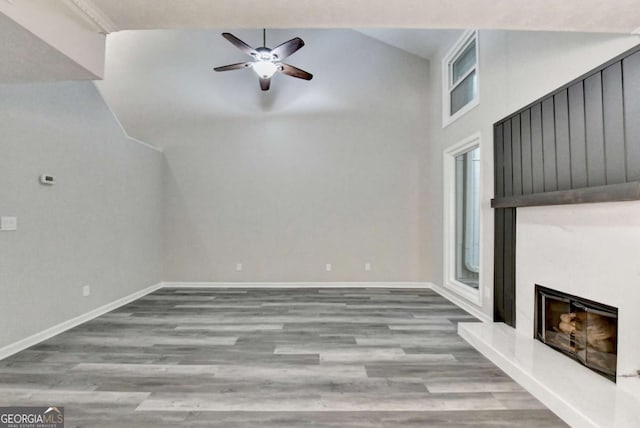 6221 Willow Run Rd, Peachtree Corners, GA 30092 - unfurnished living room with lofted ceiling, wood finished floors, a ceiling fan, and a high end fireplace