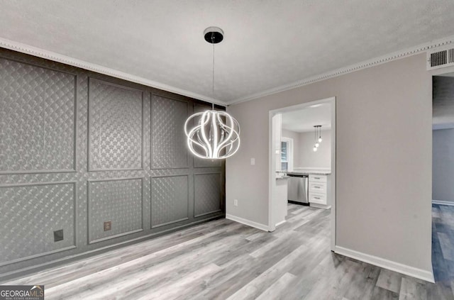 6221 Willow Run Rd, Peachtree Corners, GA 30092 - unfurnished dining area with a chandelier, wood finished floors, and crown molding