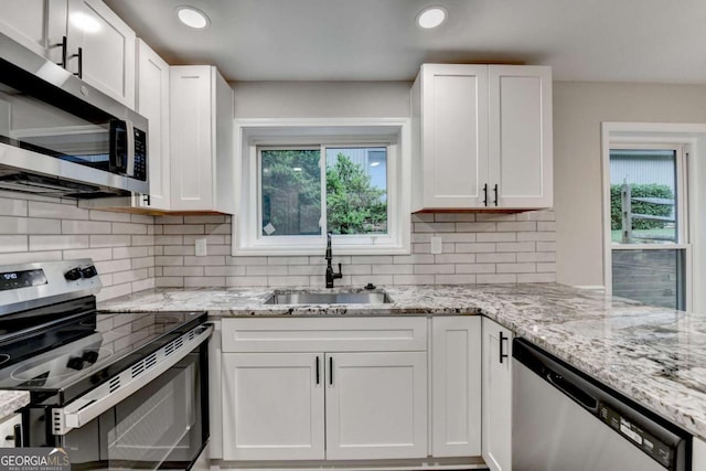 6221 Willow Run Rd, Peachtree Corners, GA 30092 - kitchen with appliances with stainless steel finishes, white cabinetry, plenty of natural light, and recessed lighting