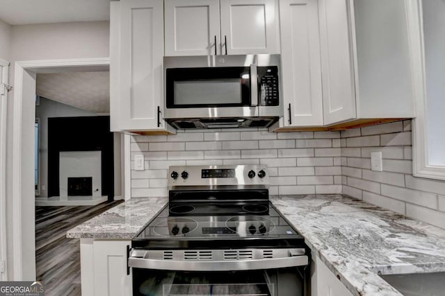 6221 Willow Run Rd, Peachtree Corners, GA 30092 - kitchen featuring stainless steel appliances, decorative backsplash, white cabinets, and light stone countertops