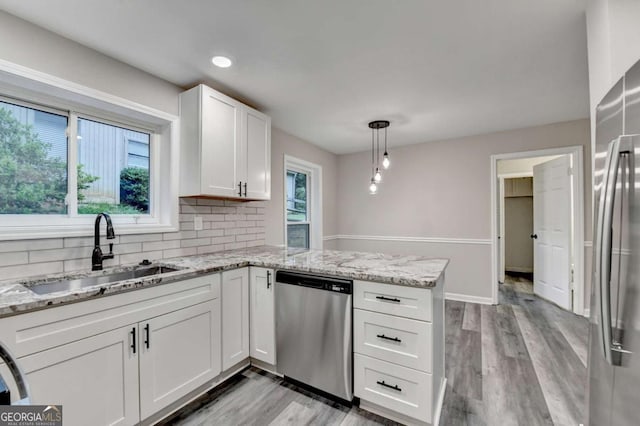 6221 Willow Run Rd, Peachtree Corners, GA 30092 - kitchen with stainless steel appliances, a peninsula, white cabinets, backsplash, and light wood-style floors