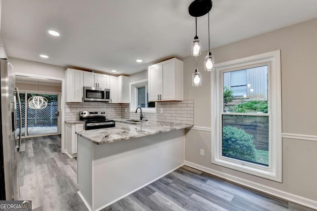 6221 Willow Run Rd, Peachtree Corners, GA 30092 - kitchen with appliances with stainless steel finishes, white cabinetry, backsplash, light wood finished floors, and recessed lighting