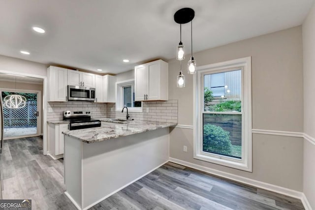 6221 Willow Run Rd, Peachtree Corners, GA 30092 - kitchen featuring stainless steel appliances, white cabinetry, backsplash, light stone countertops, and recessed lighting