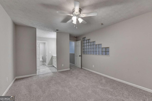 6221 Willow Run Rd, Peachtree Corners, GA 30092 - unfurnished bedroom featuring carpet, a textured ceiling, connected bathroom, and ceiling fan