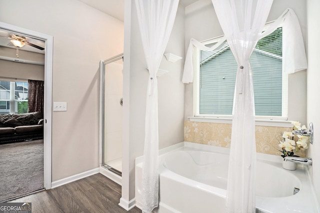 176 Malbone St SW, Cartersville, GA 30120 - full bathroom with a bath, wood finished floors, a shower stall, and a ceiling fan