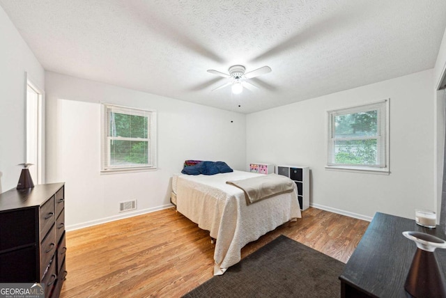 155 Windy Hill Ct, Alpharetta, GA 30004 - bedroom featuring light wood finished floors, a textured ceiling, and a ceiling fan