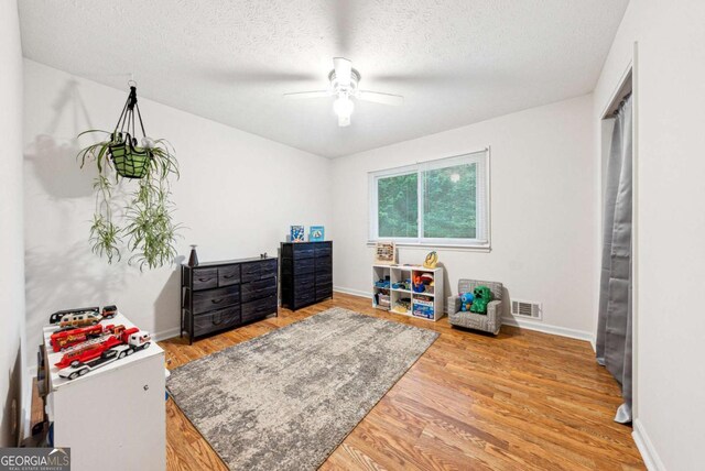 155 Windy Hill Ct, Alpharetta, GA 30004 - rec room featuring ceiling fan, wood finished floors, and a textured ceiling