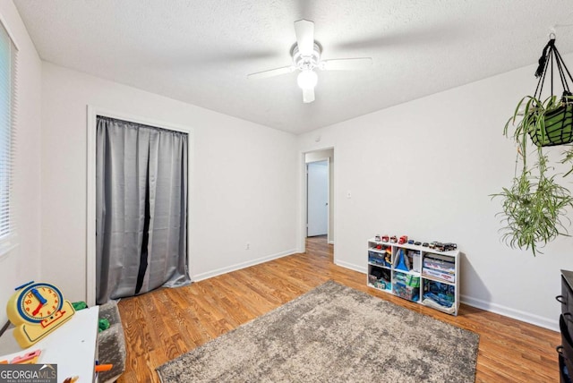 155 Windy Hill Ct, Alpharetta, GA 30004 - playroom with wood finished floors, a ceiling fan, and a textured ceiling