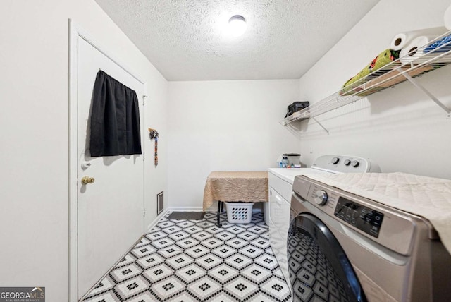 155 Windy Hill Ct, Alpharetta, GA 30004 - laundry area featuring washing machine and dryer and a textured ceiling