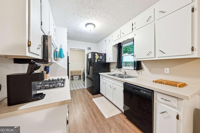 155 Windy Hill Ct, Alpharetta, GA 30004 - kitchen featuring black appliances, light wood-type flooring, light countertops, white cabinets, and a textured ceiling