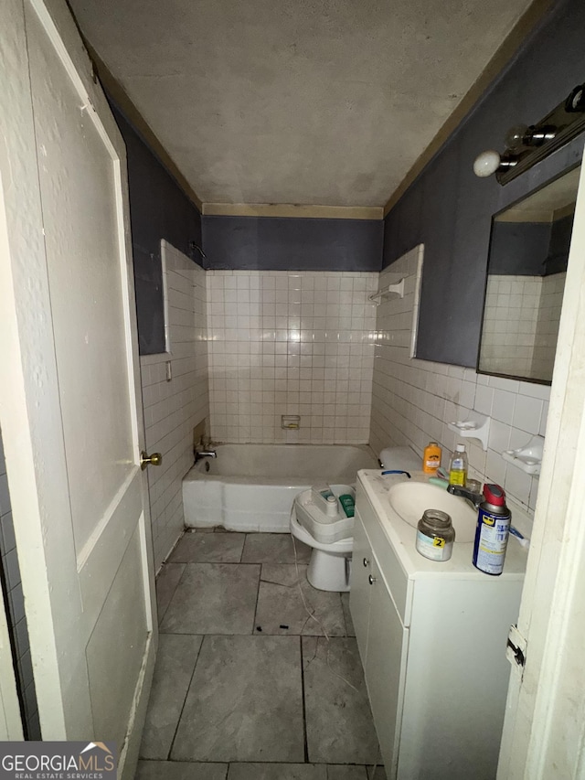 8373 Chicago Ave, Douglasville, GA 30134 - full bathroom featuring vanity, tile patterned floors, tile walls, and shower / washtub combination