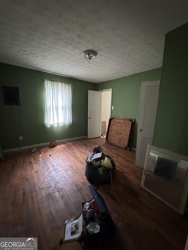 8373 Chicago Ave, Douglasville, GA 30134 - unfurnished living room with a textured ceiling and wood finished floors