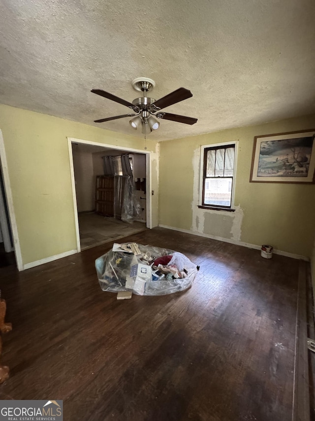 8373 Chicago Ave, Douglasville, GA 30134 - unfurnished living room featuring a textured ceiling, ceiling fan, and wood finished floors