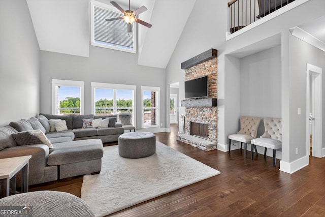 2112 Meadowood Cv, Monroe, GA 30655 - living area featuring high vaulted ceiling, a fireplace, ceiling fan, and dark wood-style floors
