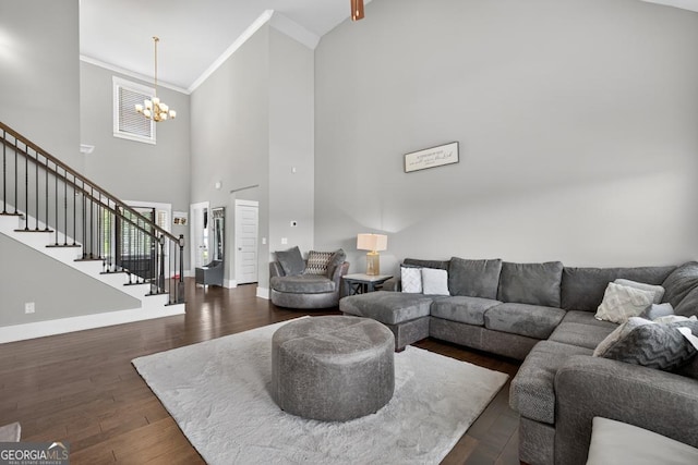 2112 Meadowood Cv, Monroe, GA 30655 - living area featuring a high ceiling, stairway, a chandelier, ornamental molding, and dark wood-style floors