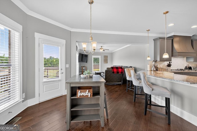 2112 Meadowood Cv, Monroe, GA 30655 - dining space featuring ornamental molding, dark wood-style flooring, a chandelier, and recessed lighting