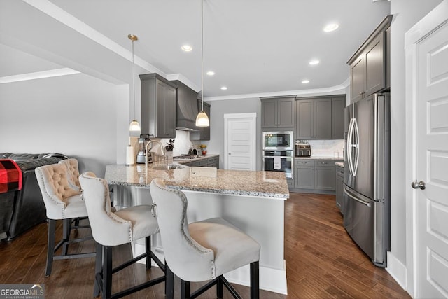 2112 Meadowood Cv, Monroe, GA 30655 - kitchen with appliances with stainless steel finishes, gray cabinetry, a peninsula, light stone counters, and crown molding