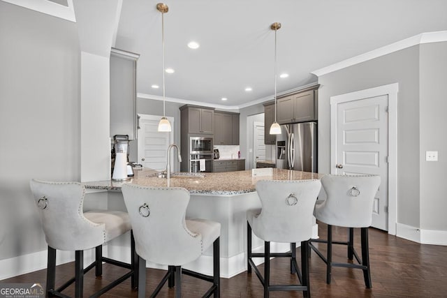 2112 Meadowood Cv, Monroe, GA 30655 - kitchen with stainless steel appliances, gray cabinets, a peninsula, light stone countertops, and ornamental molding