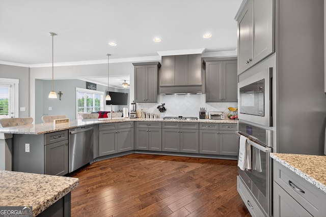 2112 Meadowood Cv, Monroe, GA 30655 - kitchen with stainless steel appliances, gray cabinets, a peninsula, ornamental molding, and plenty of natural light